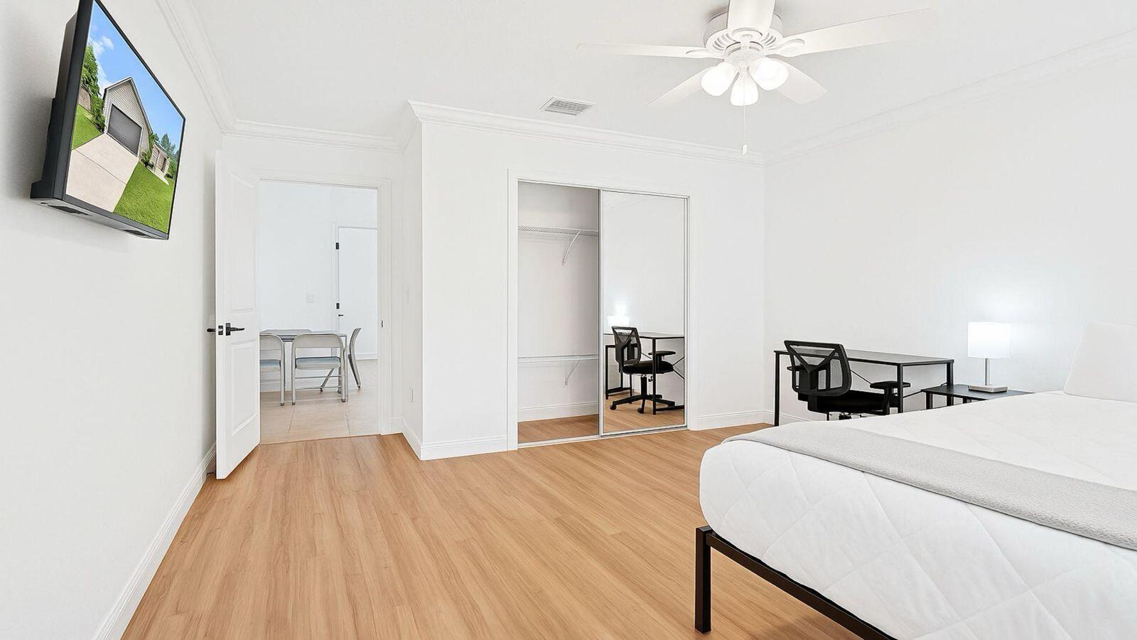 1075 West 30th Street Riviera Beach, FL 33404 - Photo 44 of 66 a bedroom with a bed and a chandelier