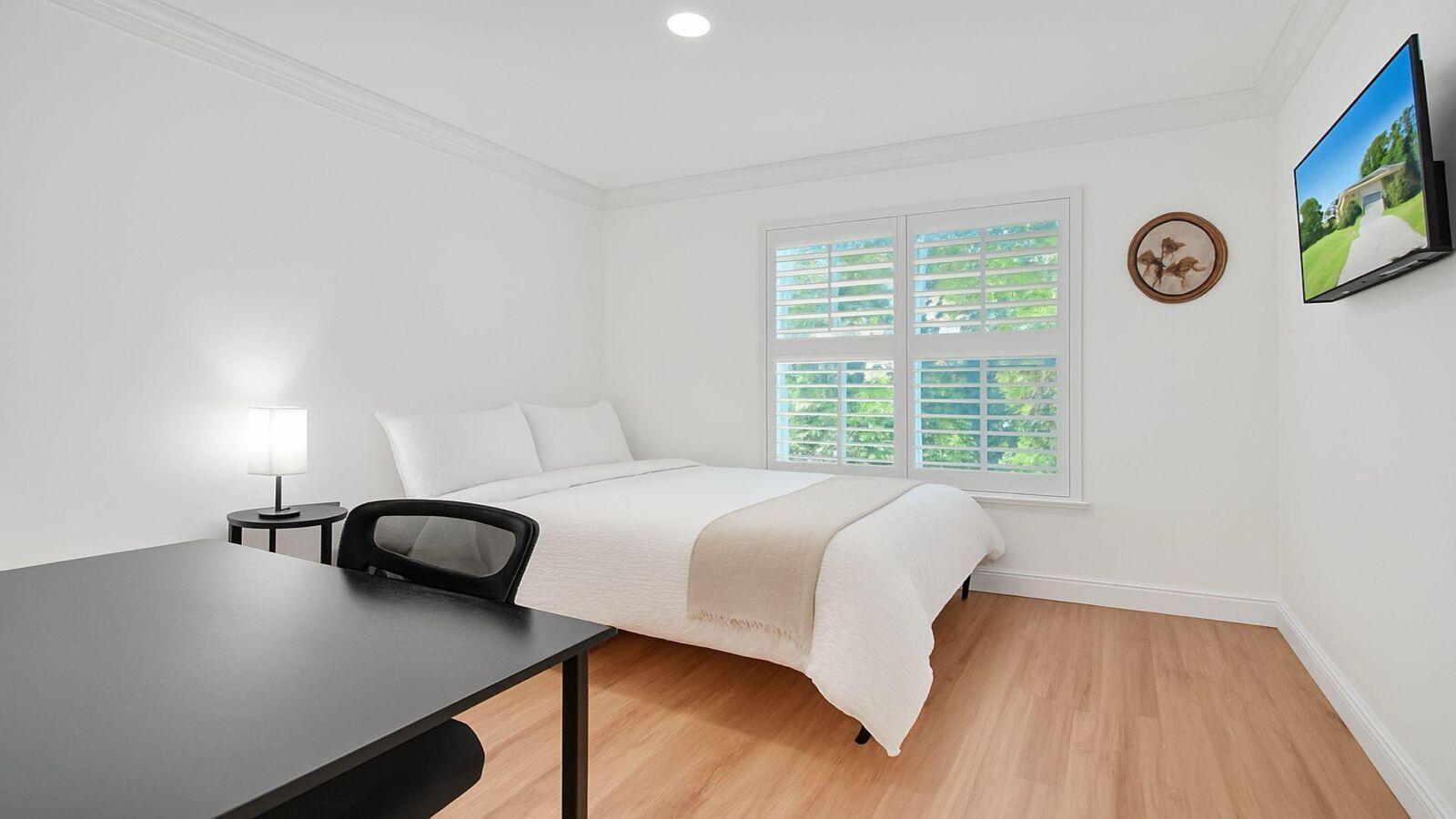 1075 West 30th Street Riviera Beach, FL 33404 - Photo 45 of 66 a bedroom with a bed and a window