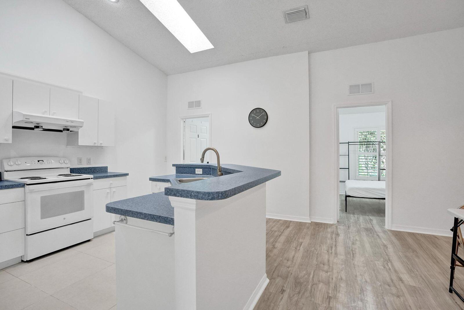 1075 West 30th Street Riviera Beach, FL 33404 - Photo 52 of 66 a kitchen with a sink and stove