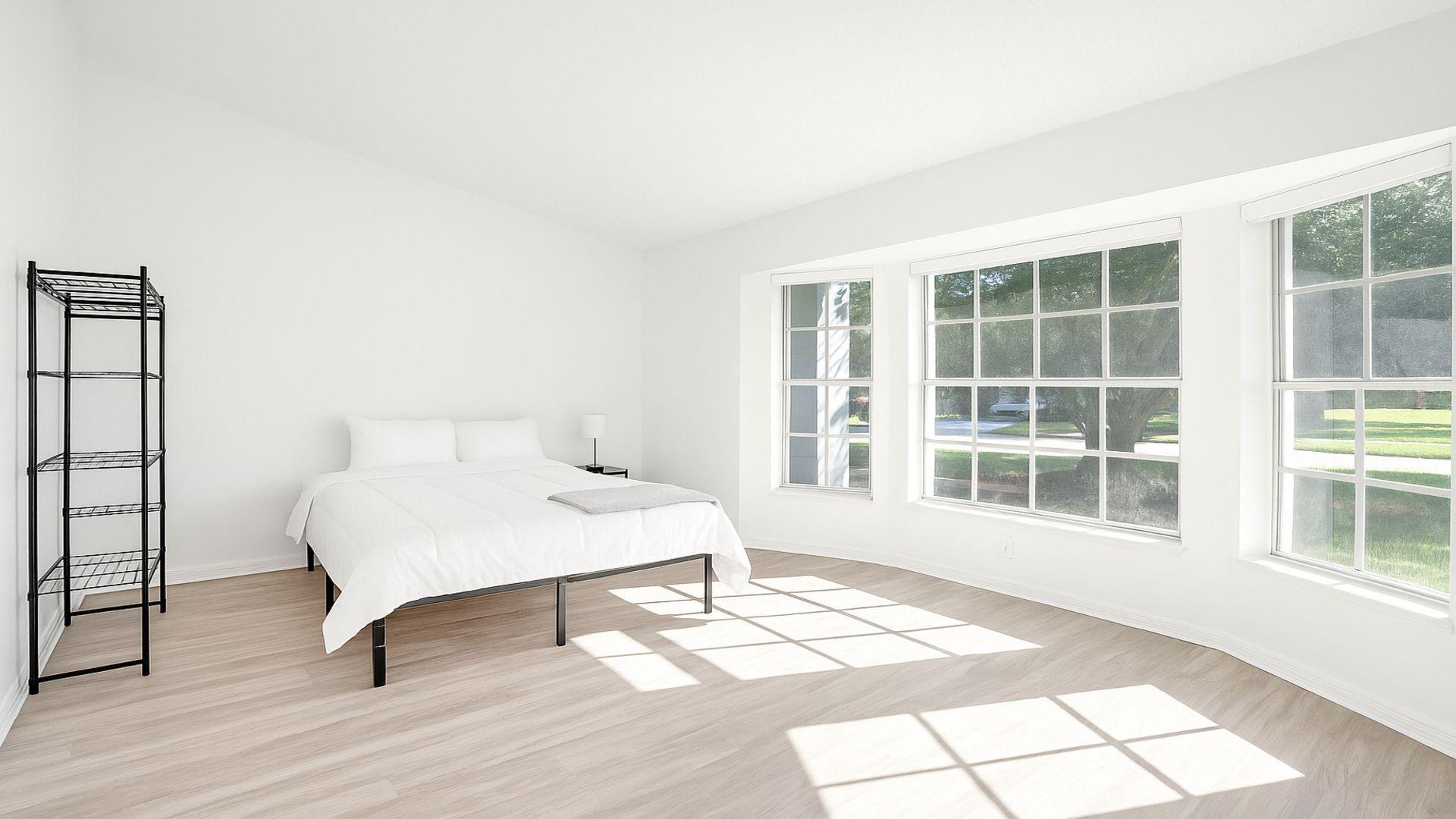 1075 West 30th Street Riviera Beach, FL 33404 - Photo 55 of 66 a bedroom with a bed and a large window