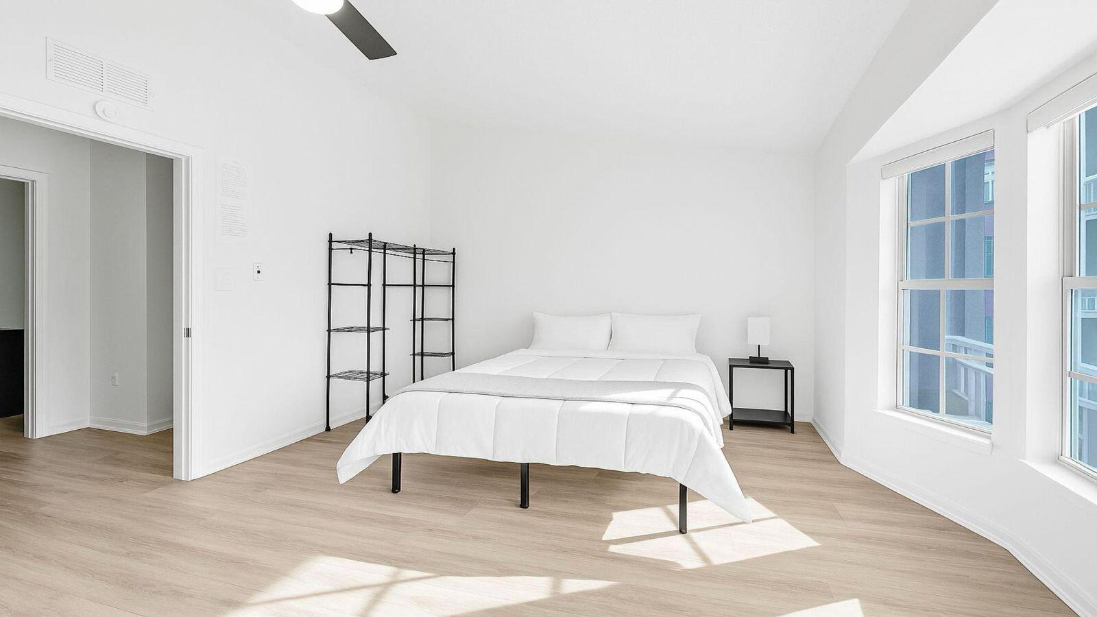 1075 West 30th Street Riviera Beach, FL 33404 - Photo 56 of 66 a bedroom with a bed and wooden floor