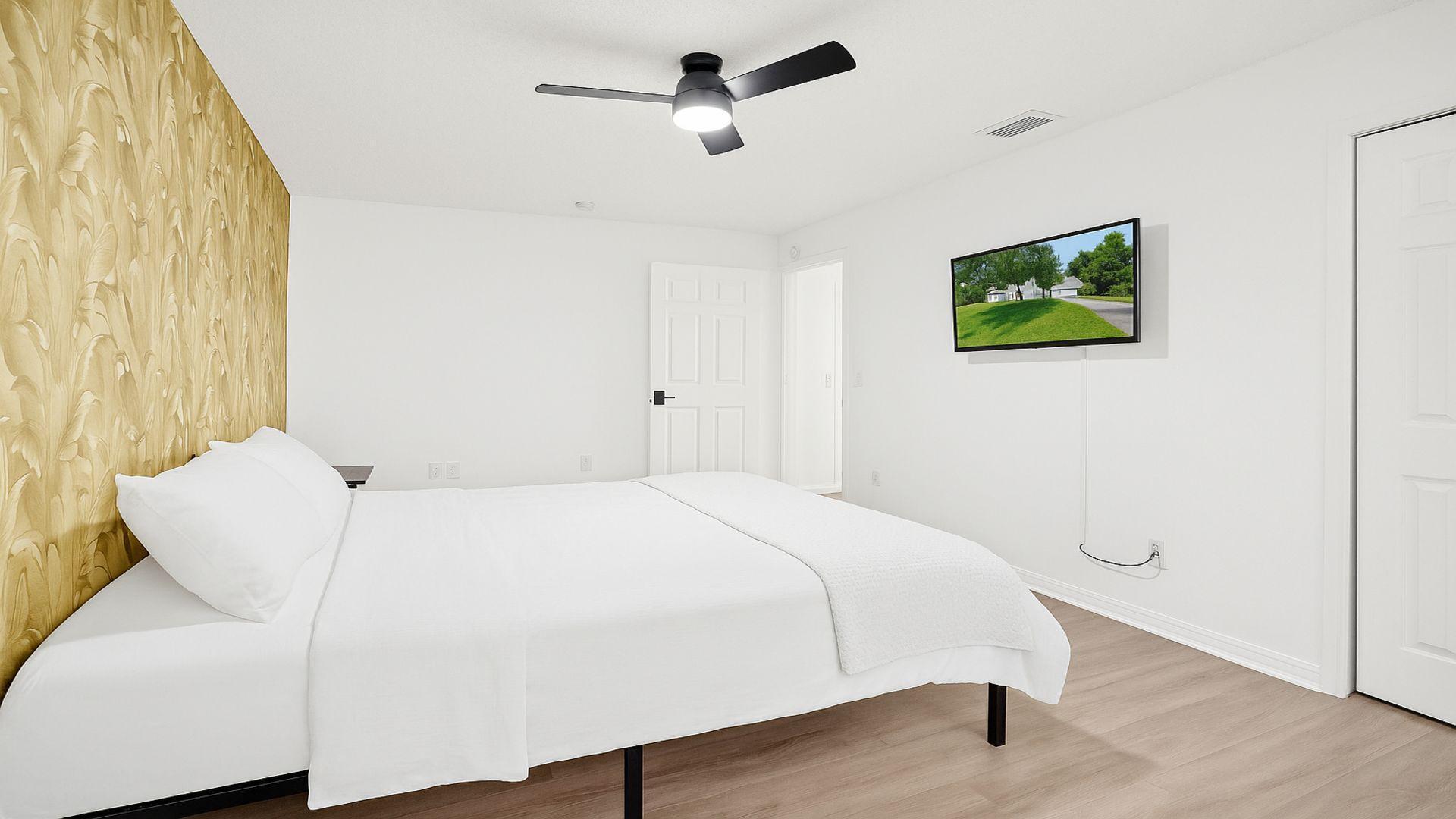 1075 West 30th Street Riviera Beach, FL 33404 - Photo 57 of 66 a bedroom with a bed and a chandelier