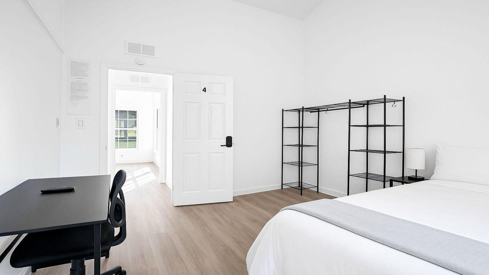 1075 West 30th Street Riviera Beach, FL 33404 - Photo 60 of 66 a bedroom with a bed chair and a window