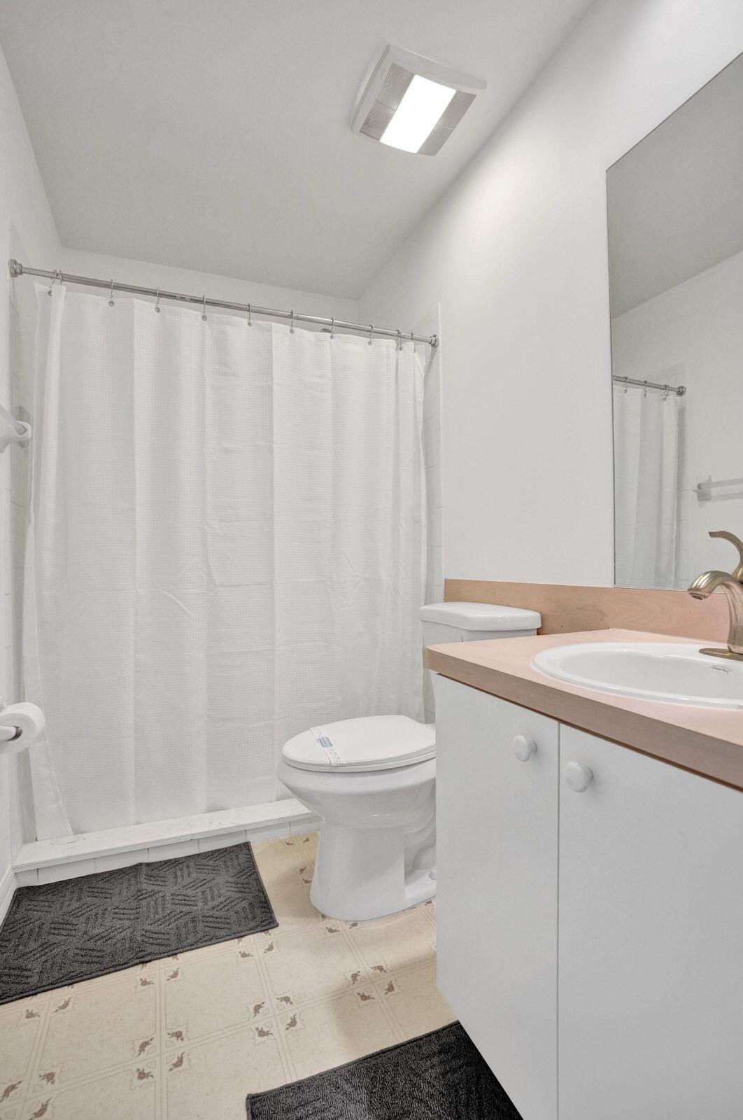 1075 West 30th Street Riviera Beach, FL 33404 - Photo 65 of 66 a bathroom with a sink a toilet and shower