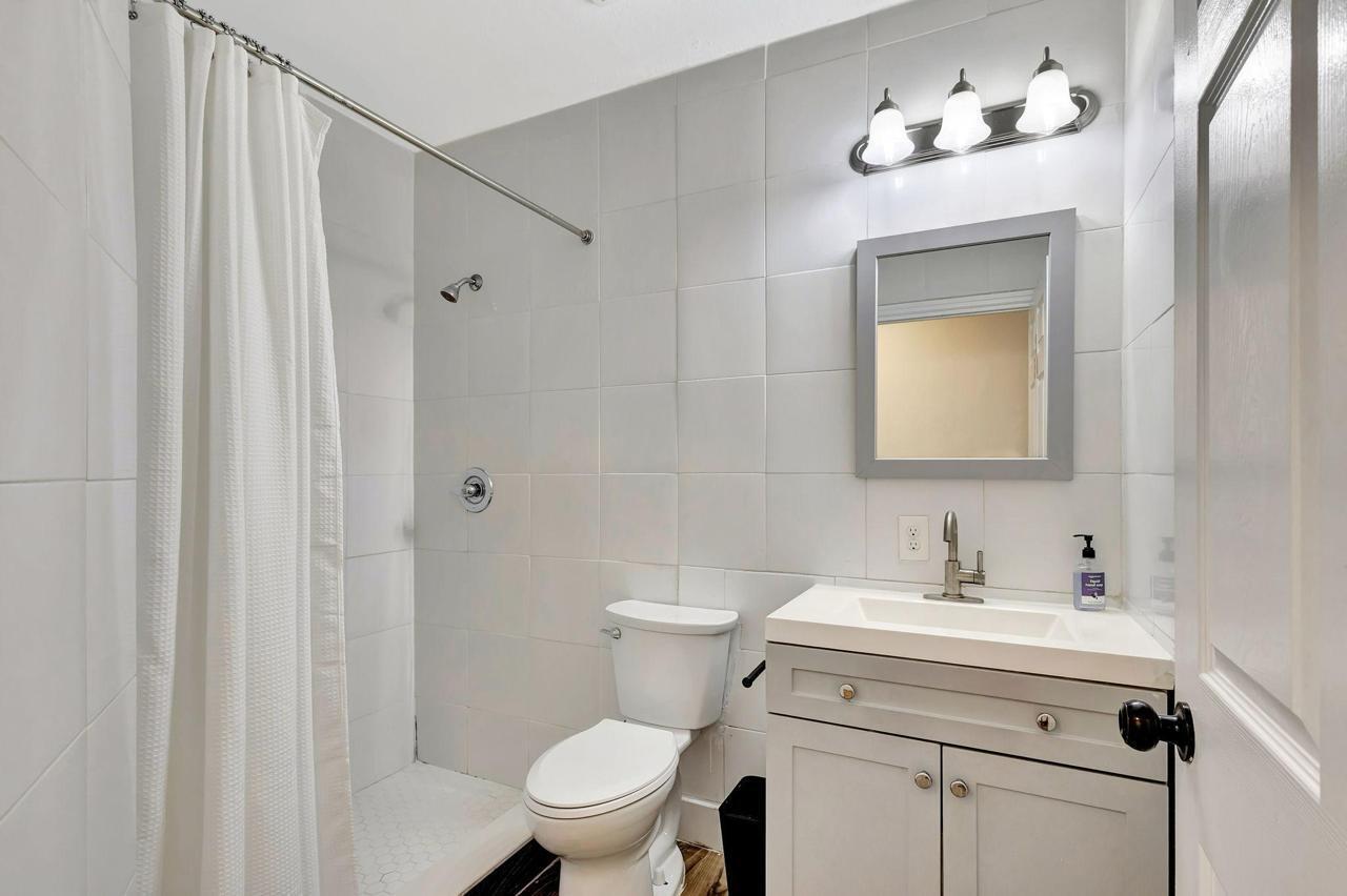 1075 West 30th Street Riviera Beach, FL 33404 - Photo 10 of 66 a bathroom with a toilet sink and mirror