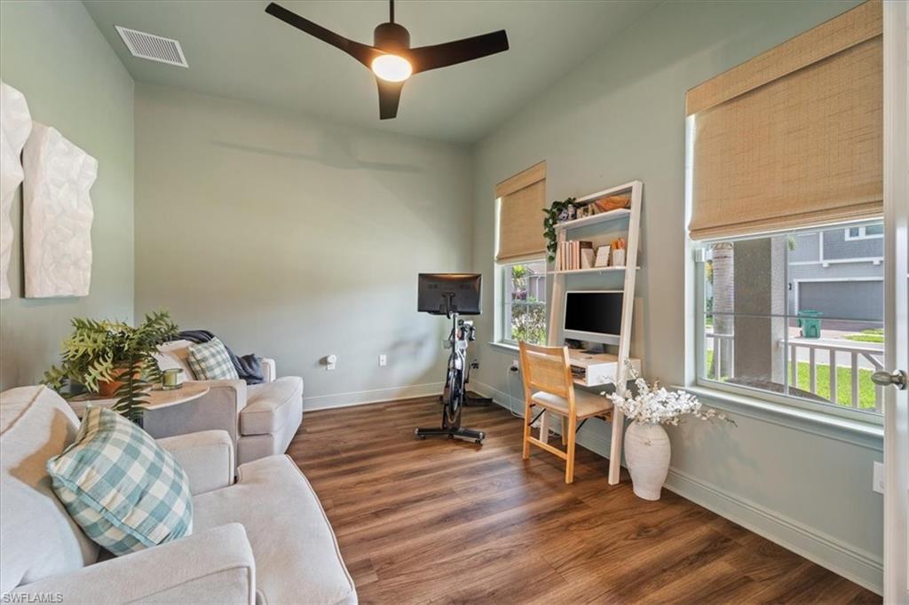 3524 Pilot Circle Naples, FL 34120 - Photo 12 of 30 a living room with furniture mirror on the wall and a flat screen tv