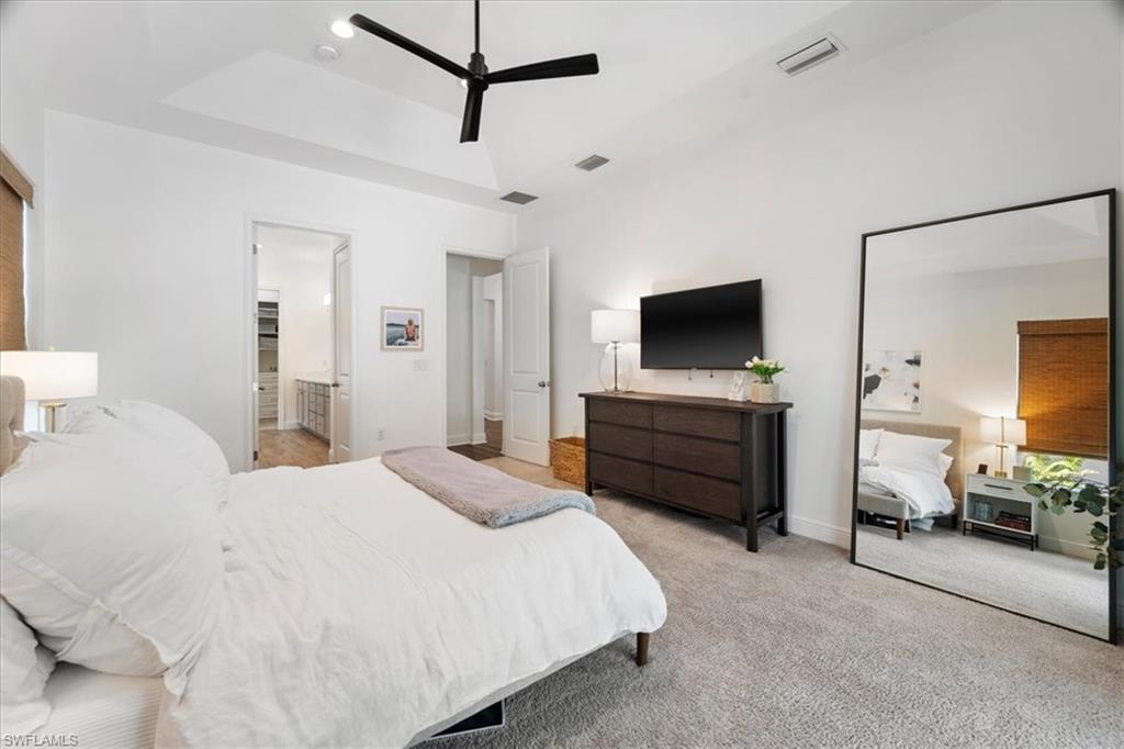 3524 Pilot Circle Naples, FL 34120 - Photo 22 of 30 a bedroom with a bed and a flat tv screen on dresser