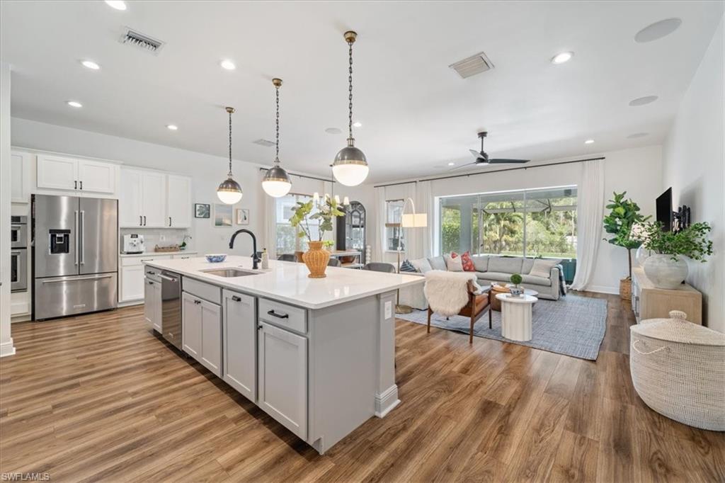 3524 Pilot Circle Naples, FL 34120 - Photo 10 of 30 a large kitchen with stainless steel appliances kitchen island a large island in the center