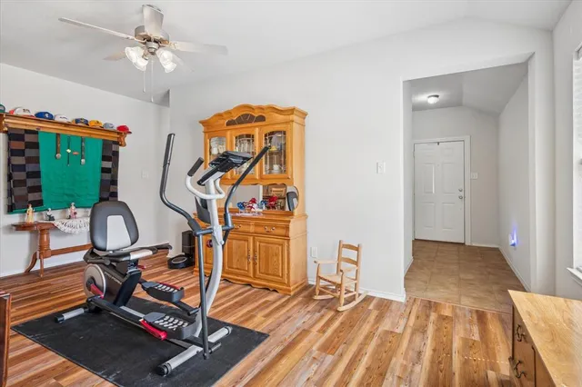 a view of a workspace with furniture and a rug