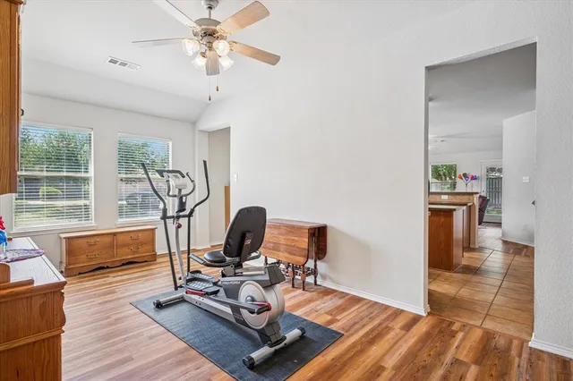 a view of a workspace with furniture and a window