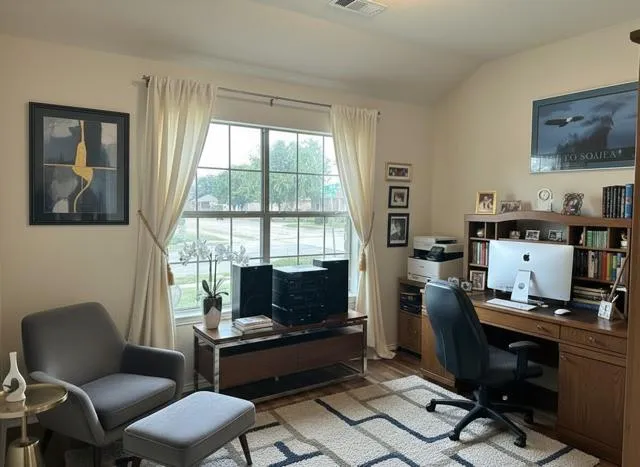 a living room with furniture a flat screen tv and a window