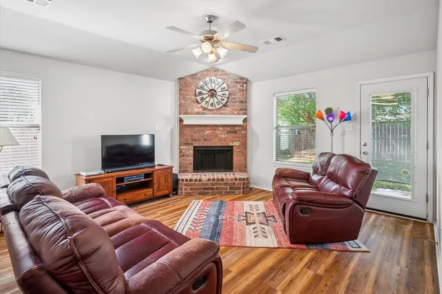 a living room with furniture a fireplace and a flat screen tv