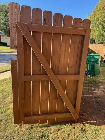 a view of a house with wooden fence