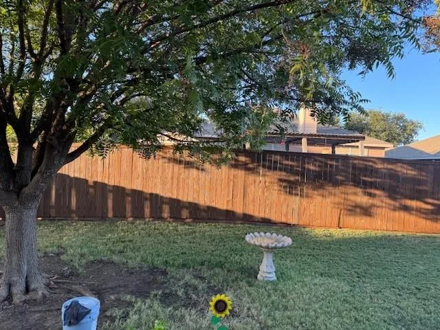 a view of a backyard with plants and lake