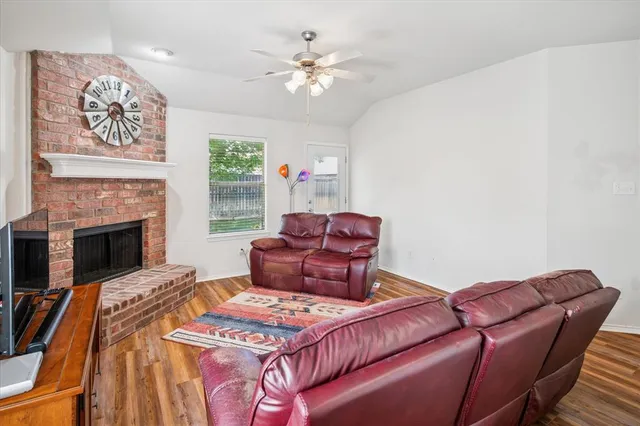 a living room with furniture a fireplace and a chandelier