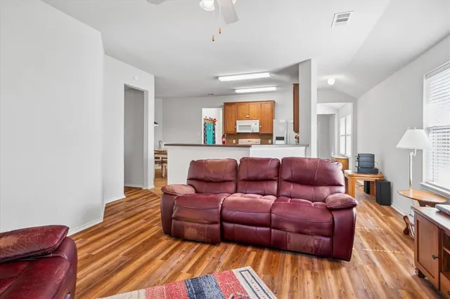a living room with furniture and a wooden floor
