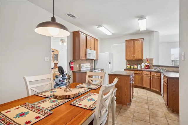 a large kitchen with a table and chairs in it