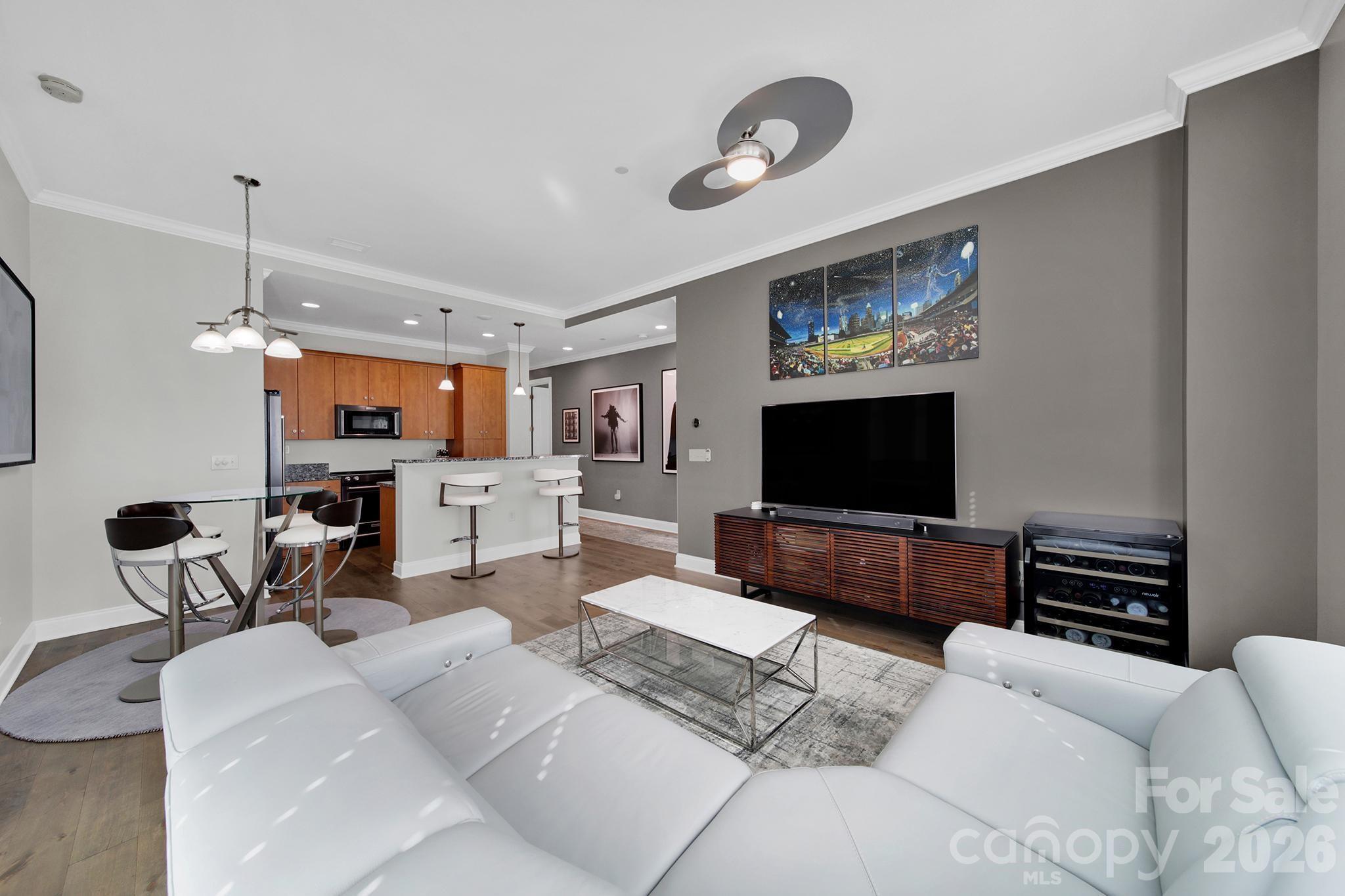 230 South Tryon Street, Unit 1004 Charlotte, NC 28281 - Photo 11 of 39 a living room with furniture and a flat screen tv