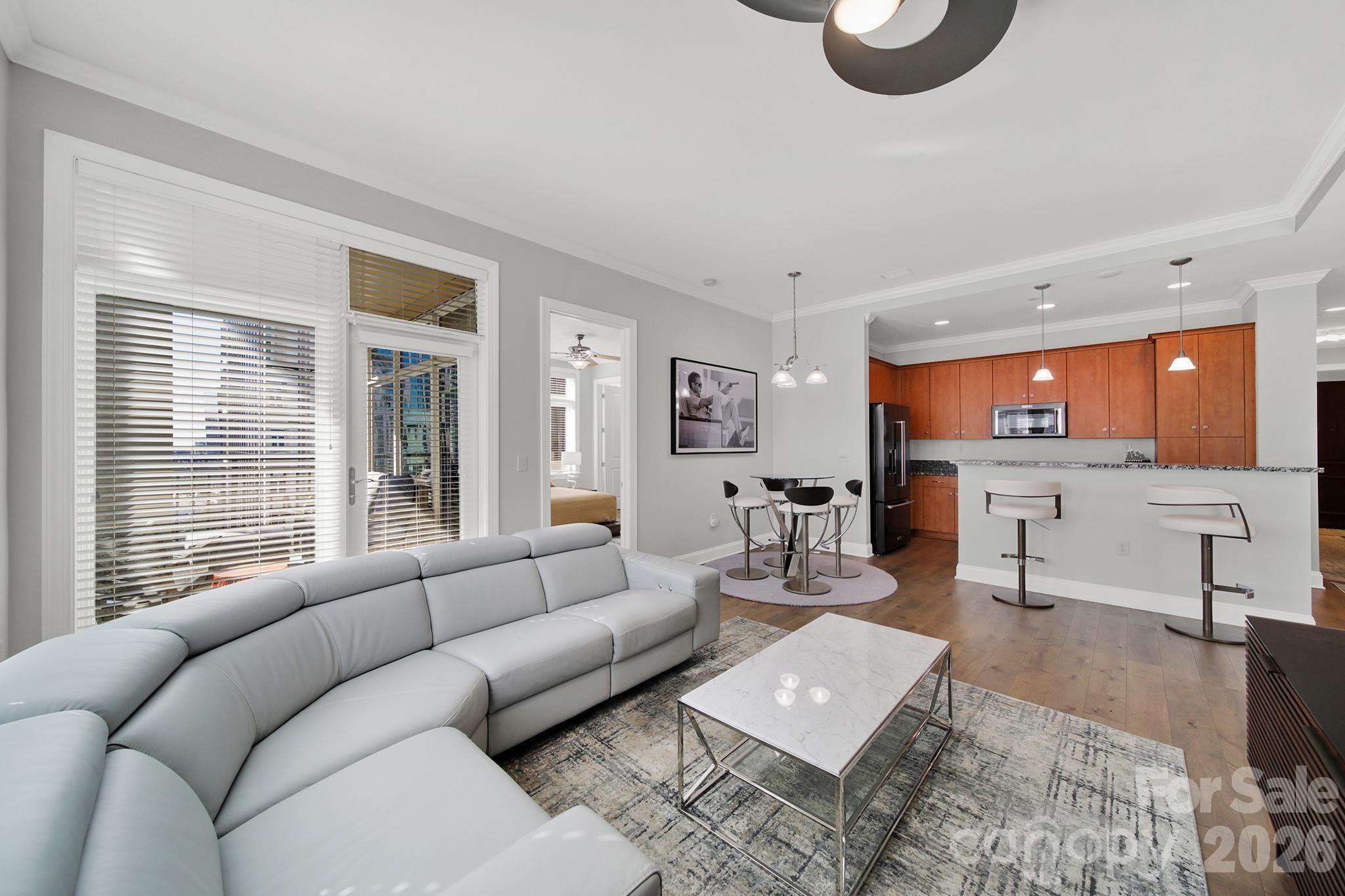230 South Tryon Street, Unit 1004 Charlotte, NC 28281 - Photo 12 of 39 a living room with furniture and a large window