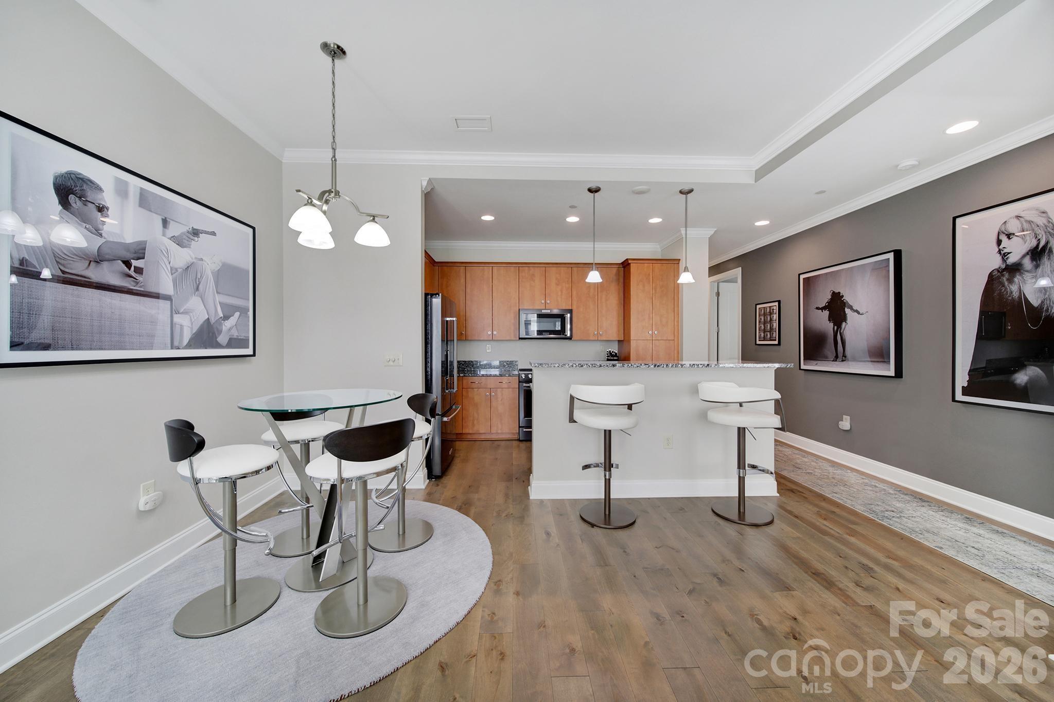 230 South Tryon Street, Unit 1004 Charlotte, NC 28281 - Photo 13 of 39 a living room with furniture and a wooden floor