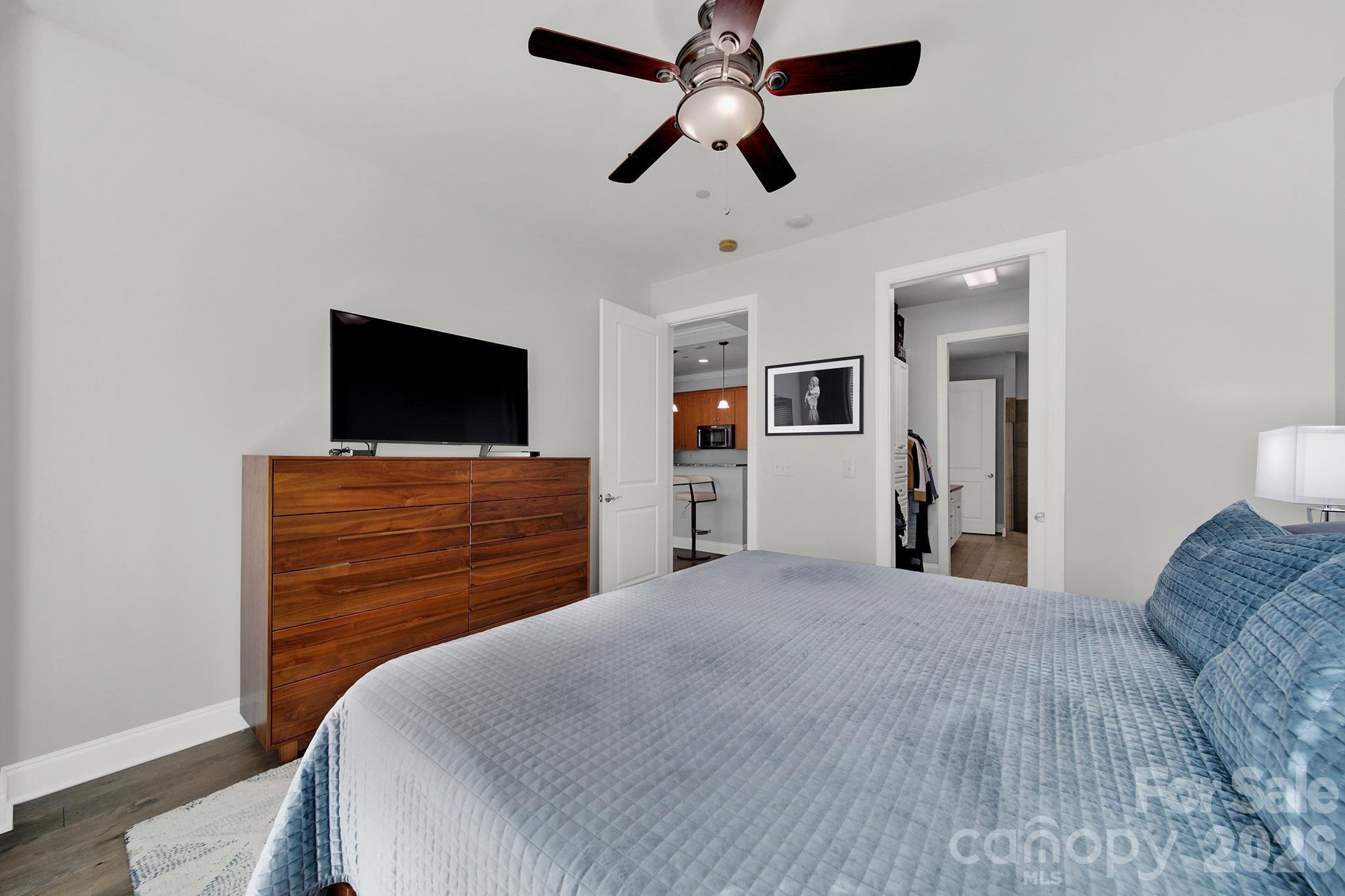 230 South Tryon Street, Unit 1004 Charlotte, NC 28281 - Photo 17 of 39 a bedroom with a bed and a flat screen tv