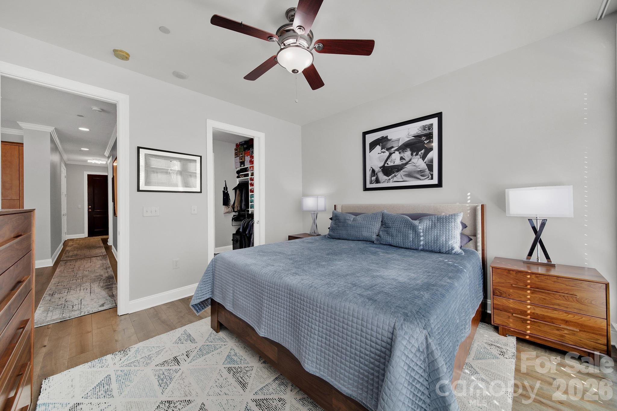 230 South Tryon Street, Unit 1004 Charlotte, NC 28281 - Photo 18 of 39 a bedroom with a bed and a lamp