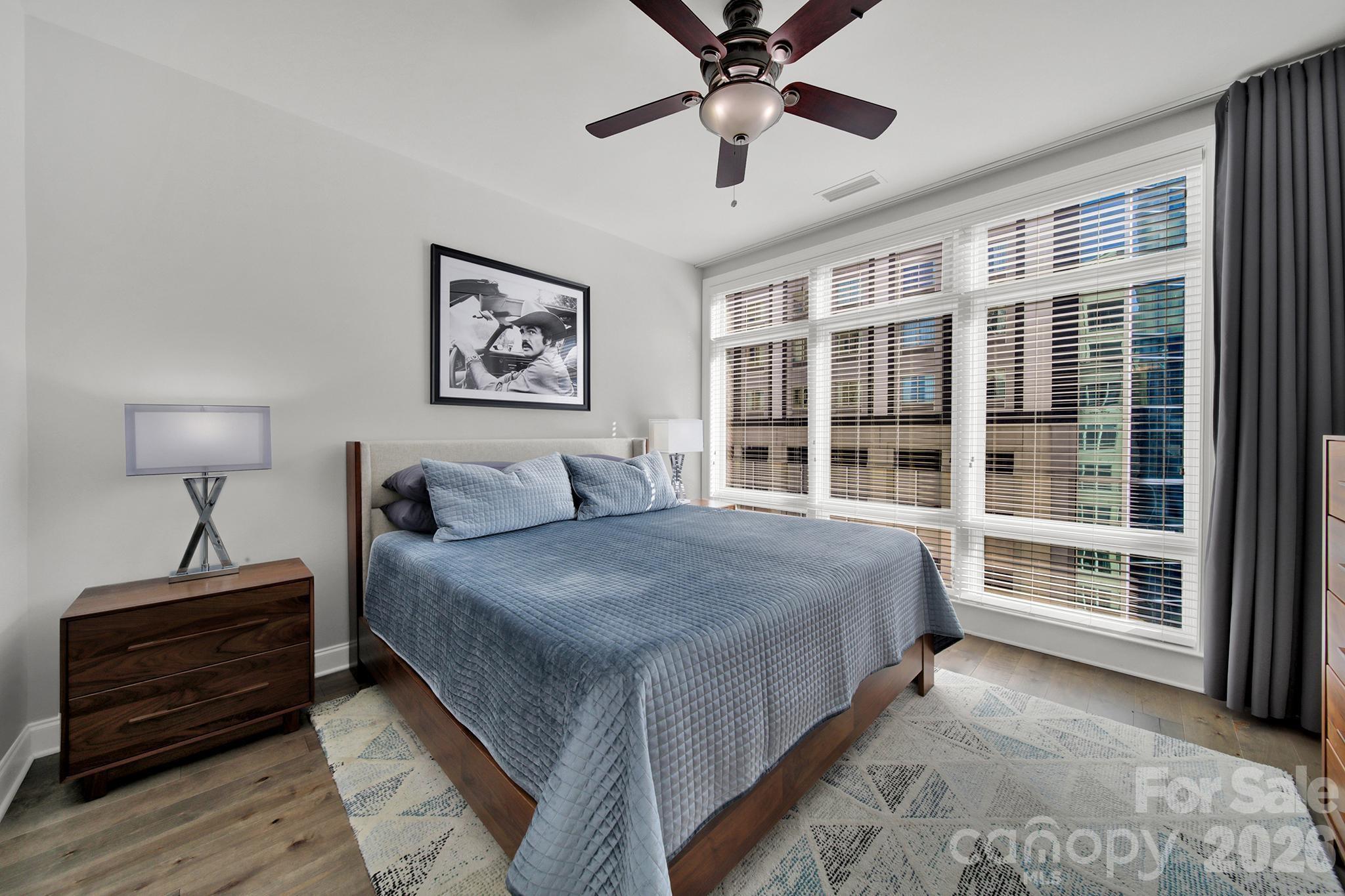 230 South Tryon Street, Unit 1004 Charlotte, NC 28281 - Photo 19 of 39 a bedroom with a large bed and a window