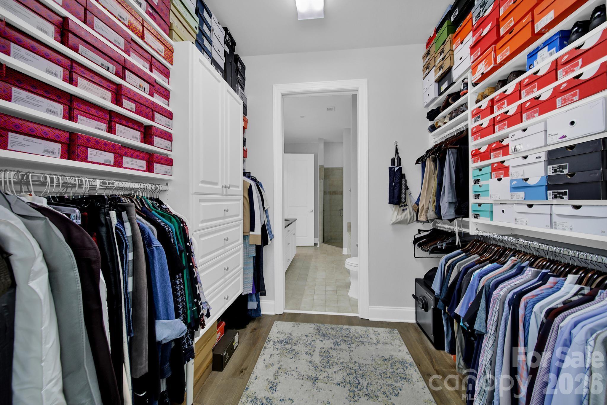 230 South Tryon Street, Unit 1004 Charlotte, NC 28281 - Photo 20 of 39 a view of walk in closet with clothes and shoes