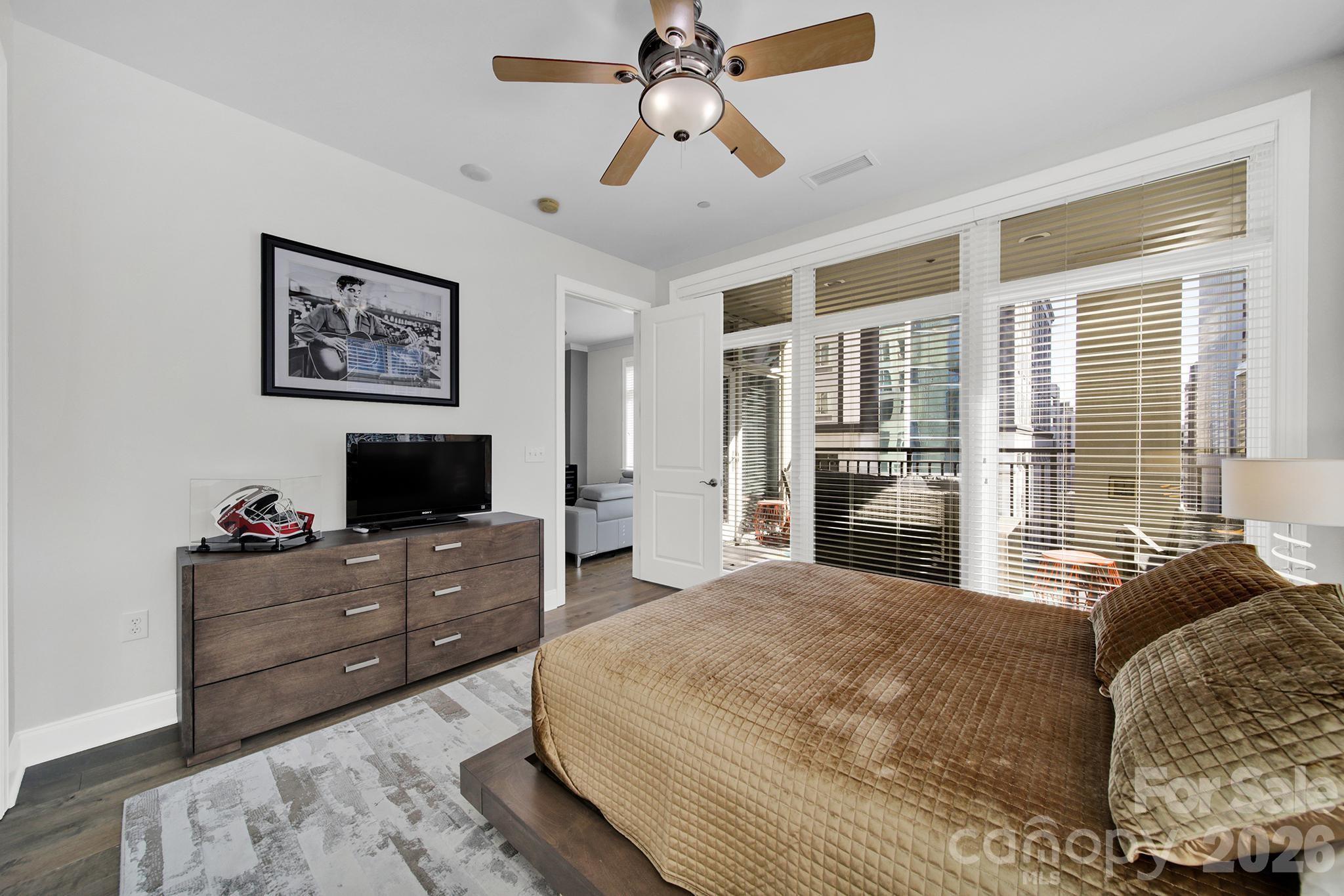 230 South Tryon Street, Unit 1004 Charlotte, NC 28281 - Photo 22 of 39 a bedroom with a bed and a flat screen tv