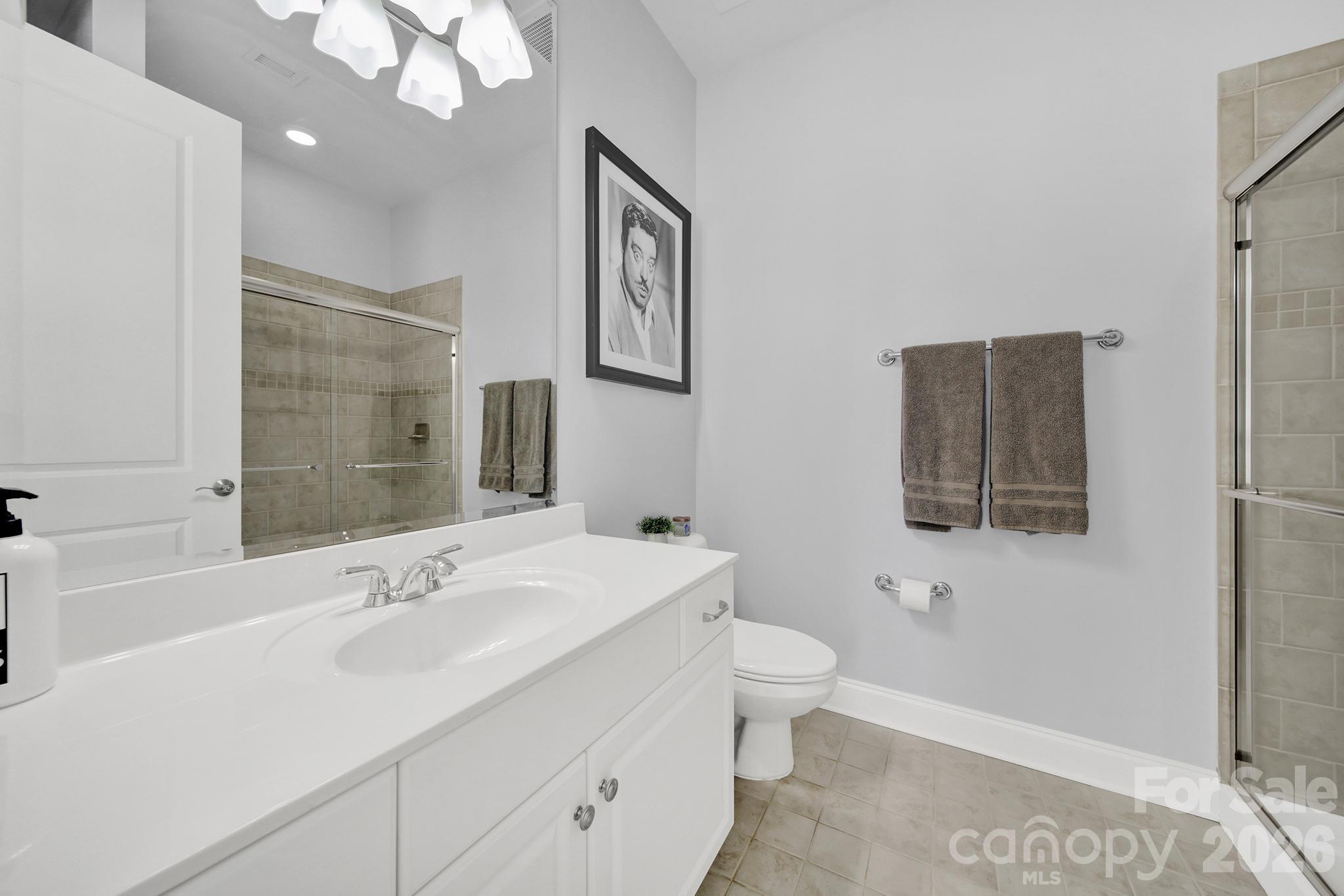 230 South Tryon Street, Unit 1004 Charlotte, NC 28281 - Photo 23 of 39 a bathroom with a sink a toilet and shower