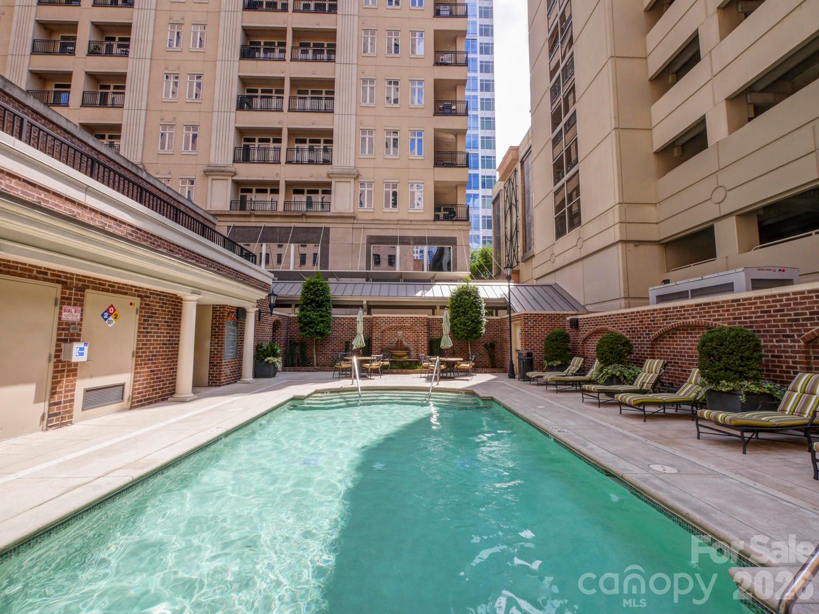 230 South Tryon Street, Unit 1004 Charlotte, NC 28281 - Photo 27 of 39 a view of a building with a yard and sitting area