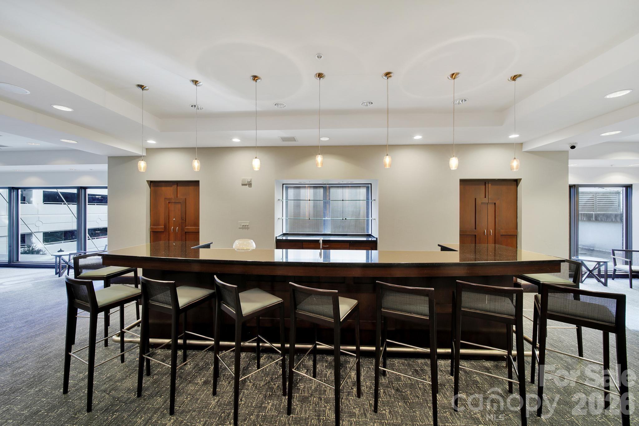 230 South Tryon Street, Unit 1004 Charlotte, NC 28281 - Photo 30 of 39 a kitchen with a table and chairs in it