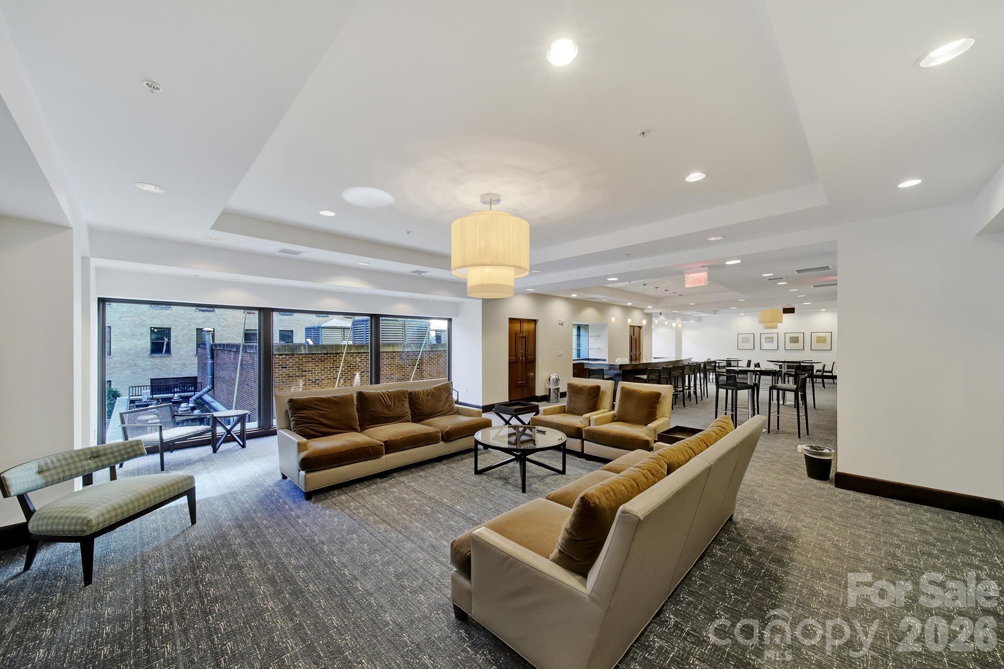 230 South Tryon Street, Unit 1004 Charlotte, NC 28281 - Photo 32 of 39 a living room with furniture and a large window