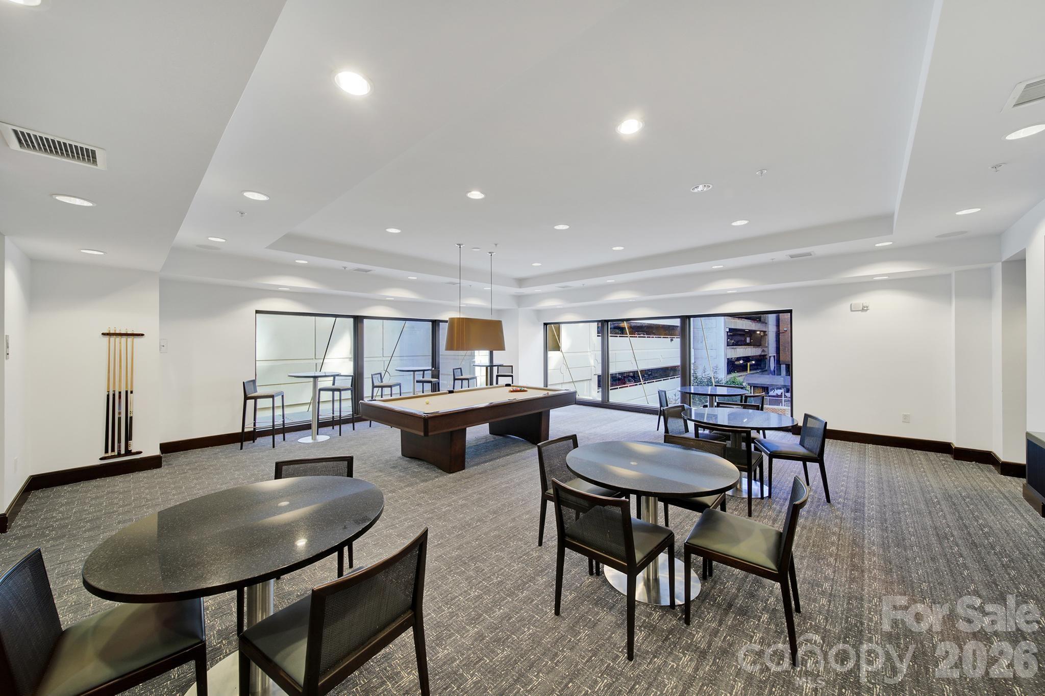 230 South Tryon Street, Unit 1004 Charlotte, NC 28281 - Photo 33 of 39 a living room with furniture and a dining table with wooden floor