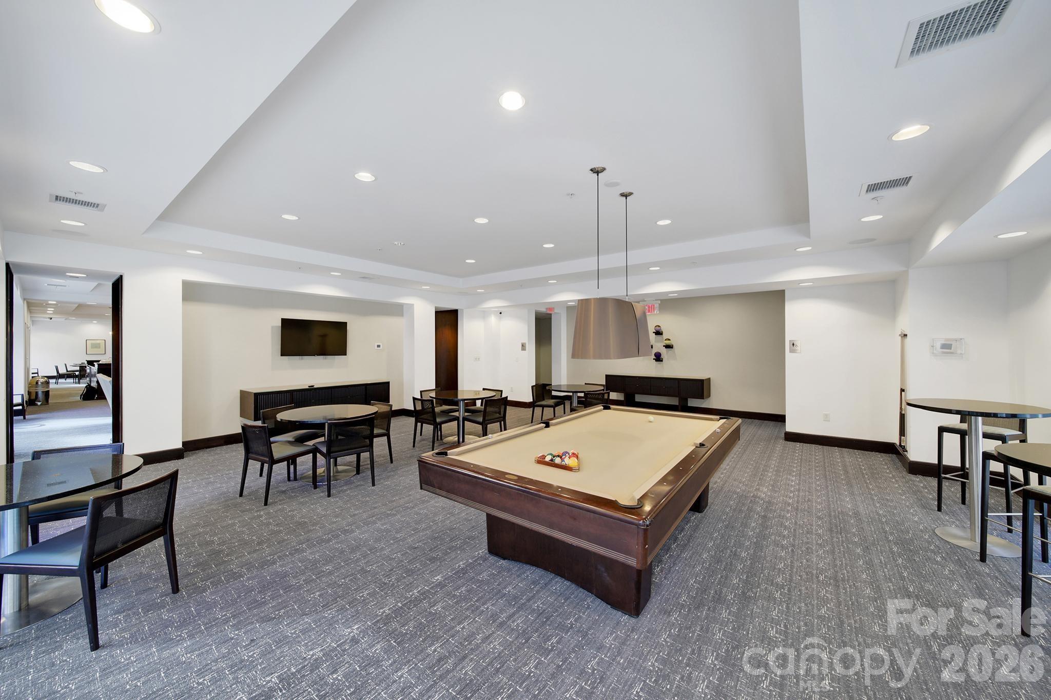 230 South Tryon Street, Unit 1004 Charlotte, NC 28281 - Photo 34 of 39 a living room with pool table and a projector screen