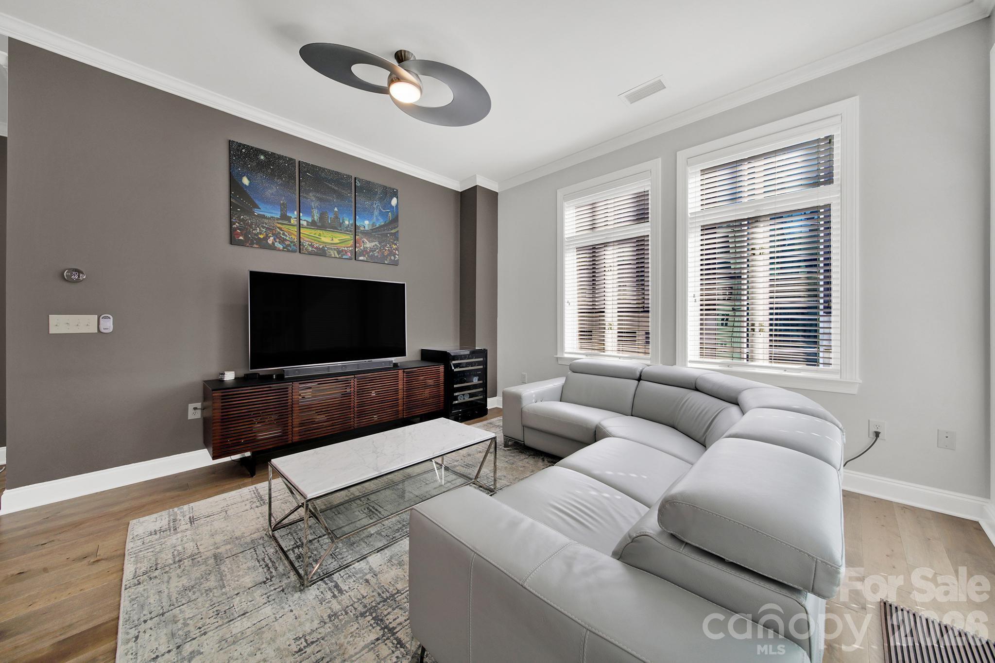 230 South Tryon Street, Unit 1004 Charlotte, NC 28281 - Photo 9 of 39 a living room with furniture and a flat screen tv