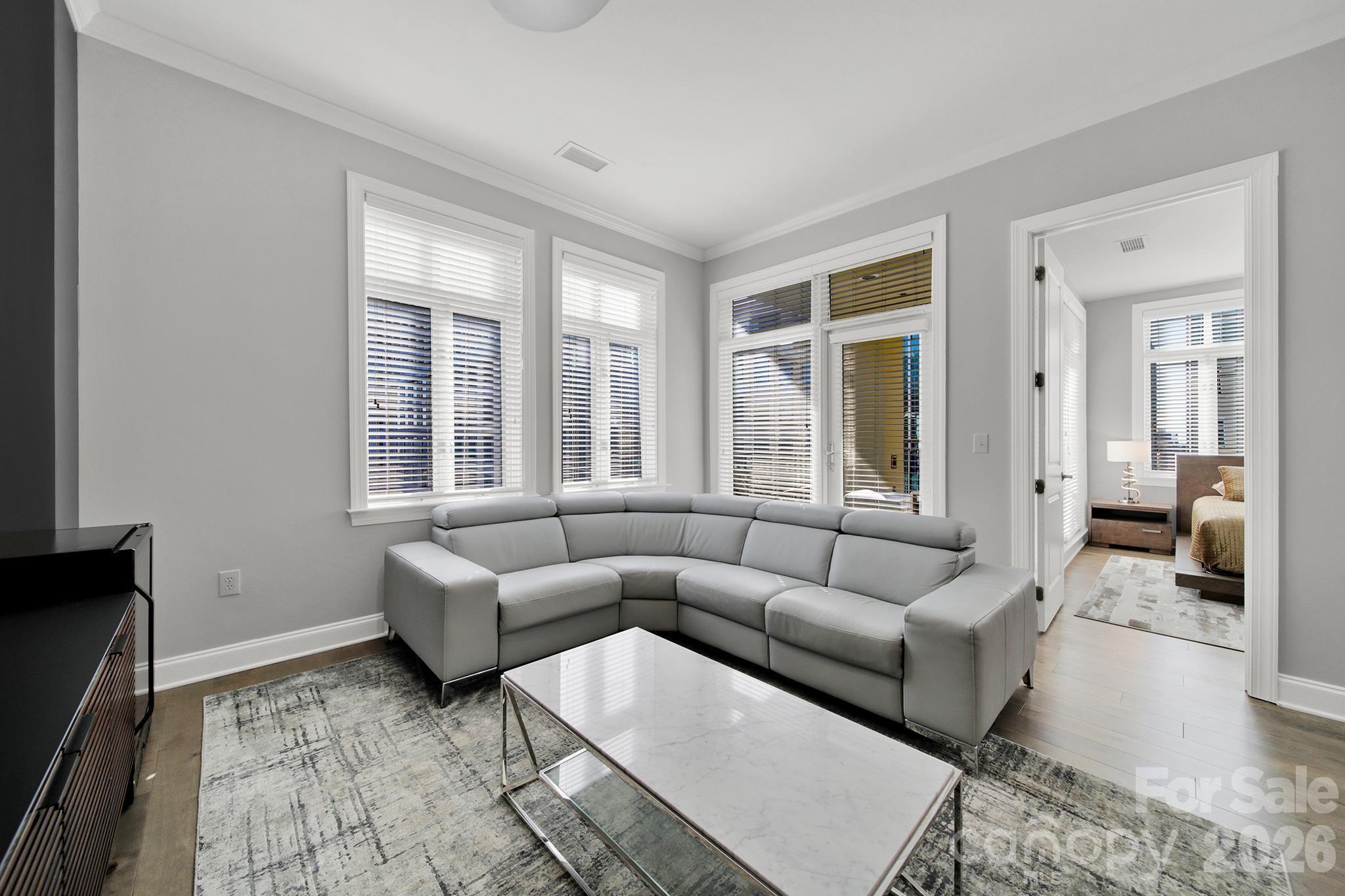 230 South Tryon Street, Unit 1004 Charlotte, NC 28281 - Photo 10 of 39 a living room with furniture and a large window