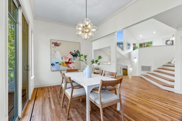 a view of a dining room with furniture wooden floor and chandelier