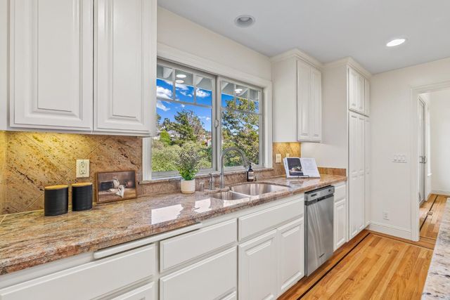 a kitchen with a sink stove and cabinets