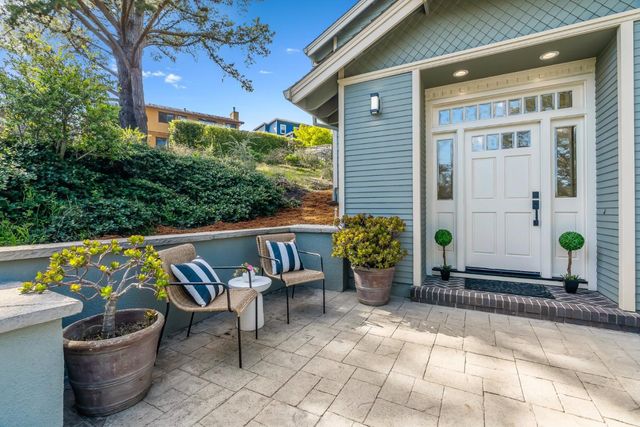 a view of a patio with table and chairs and potted plants