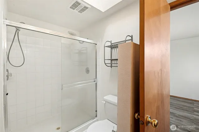 a bathroom with a shower and toilet