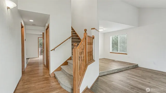 a view of entryway and hall with wooden floor