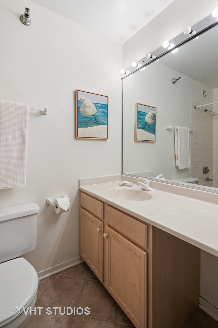 70 West Huron Street, Unit 705 Chicago, IL 60654 - Photo 8 of 16 a bathroom with a toilet sink and mirror