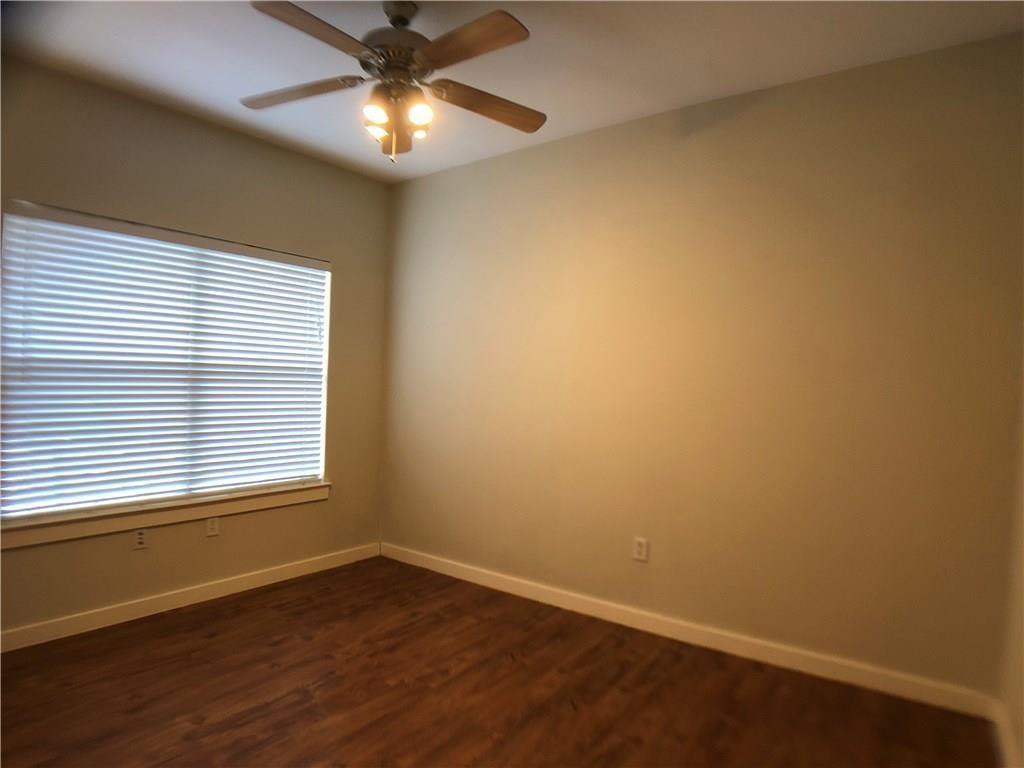 2106 Cullen Avenue, Unit 111 Austin, TX 78757 - Photo 2 of 6 Spare room featuring a ceiling fan and dark wood-style floors