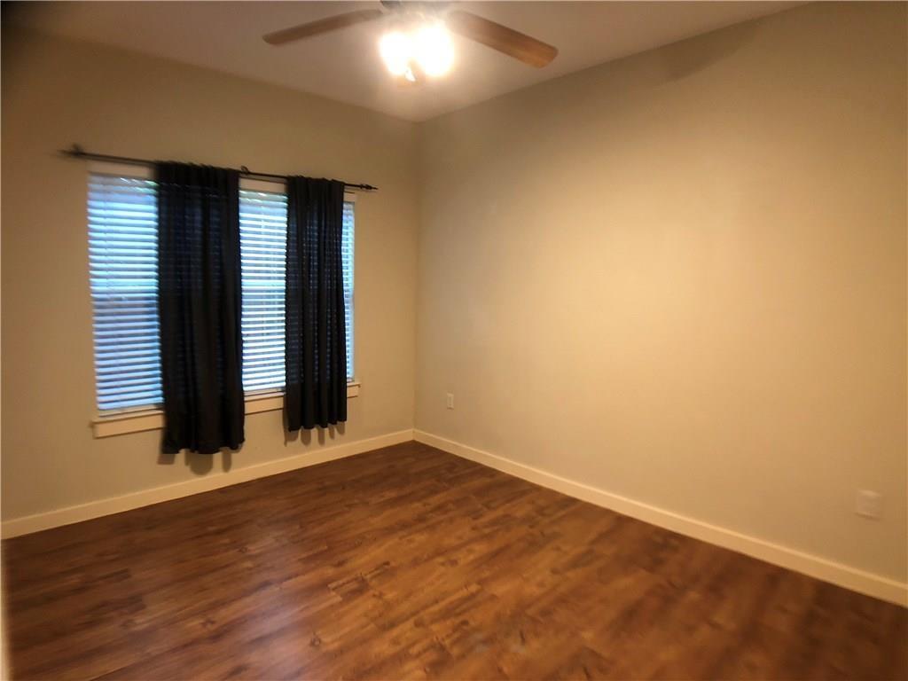 2106 Cullen Avenue, Unit 111 Austin, TX 78757 - Photo 3 of 6 Spare room with dark wood-style flooring and ceiling fan