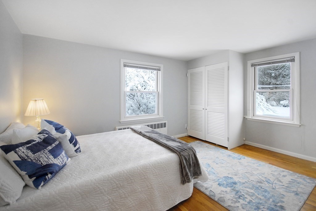 82 Powers Road Concord, MA 01742 - Photo 11 of 35 a bed sitting in a bedroom next to a window