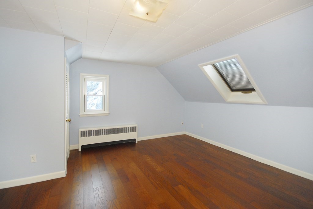 82 Powers Road Concord, MA 01742 - Photo 25 of 35 an empty room with wooden floor and windows