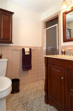 50 Gilbert Road Needham, MA 02492 - Photo 12 of 25 a bathroom with a sink a toilet and mirror
