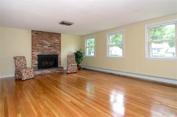 50 Gilbert Road Needham, MA 02492 - Photo 2 of 25 an empty room with windows fireplace and wooden floor