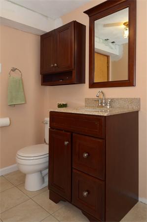 50 Gilbert Road Needham, MA 02492 - Photo 22 of 25 a bathroom with a toilet sink and mirror